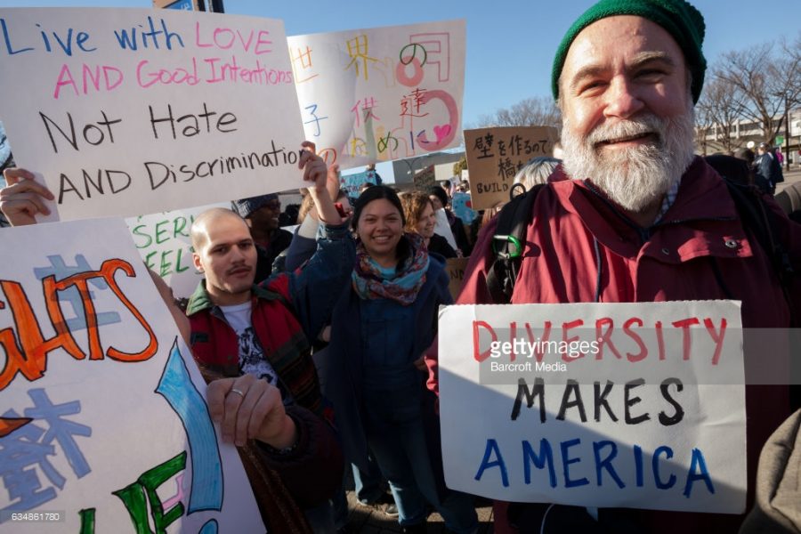 A man holds a sign saying Diversity Makes America at a protest march and rally organized by the Alliance for an Inclusive America group against the perceived anti-Muslim and anti-foreigner immigration policies by President Donald Trump. 
