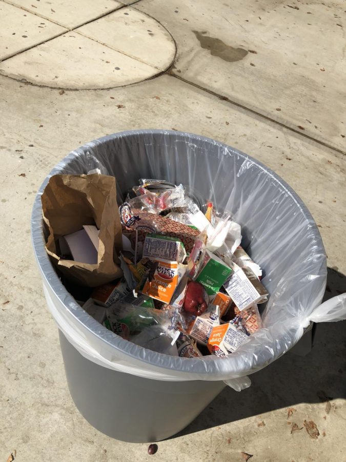 A trash can filled to the top with food of all sorts after lunch at La Quinta High School.